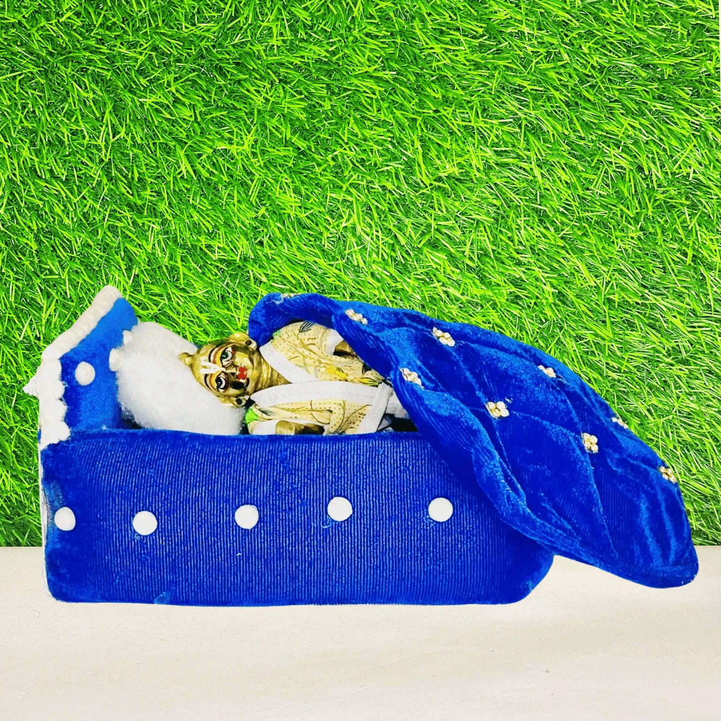 Kanha ji sleeping in a Blue Shaneel Pearl Work Wooden Laddu Gopal Bed with Blanket & Pillow.