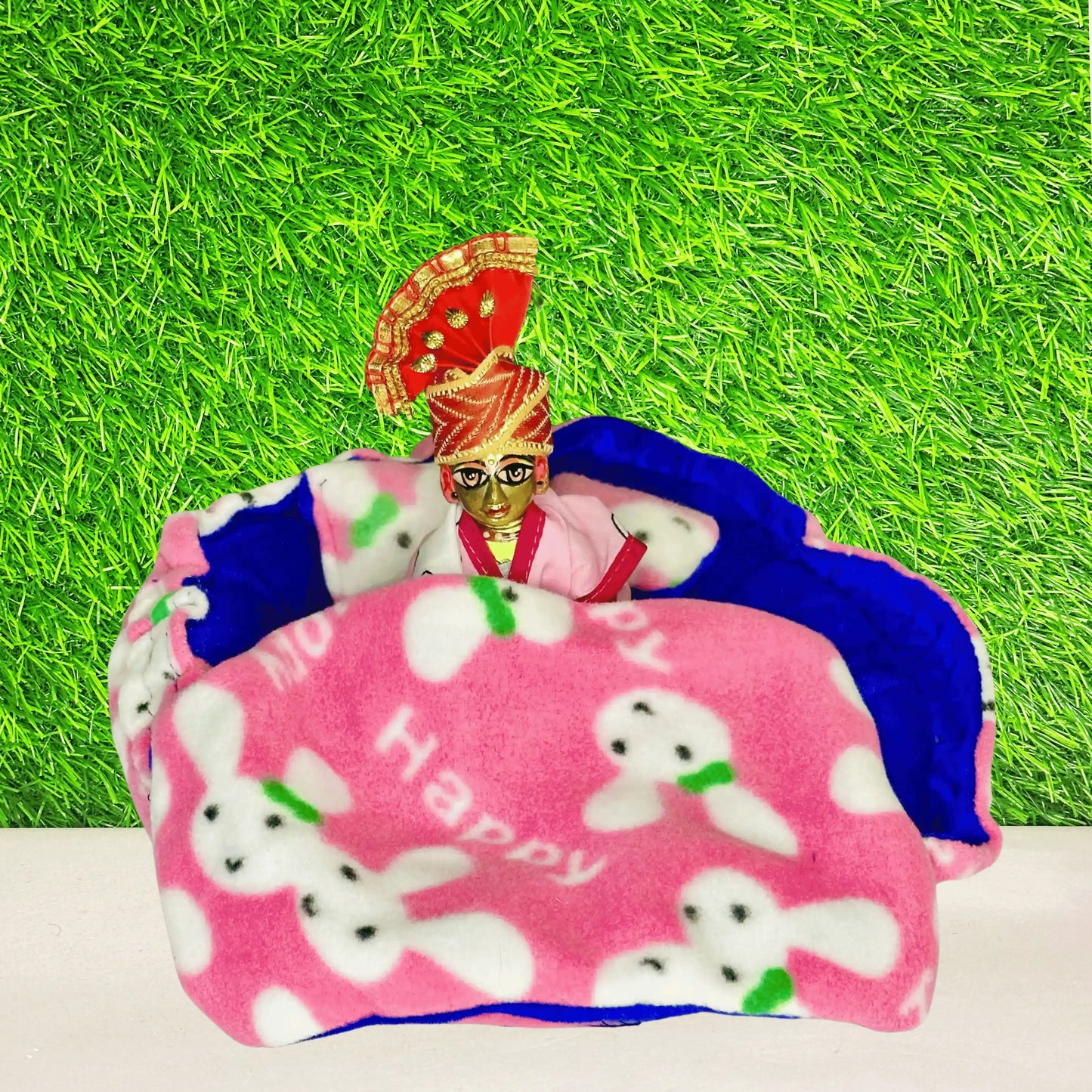 Laddu gopal ji sitting in a cute Bunny Print Laddu Gopal Bedding Set with Pink Fleece Blanket & Pillow.