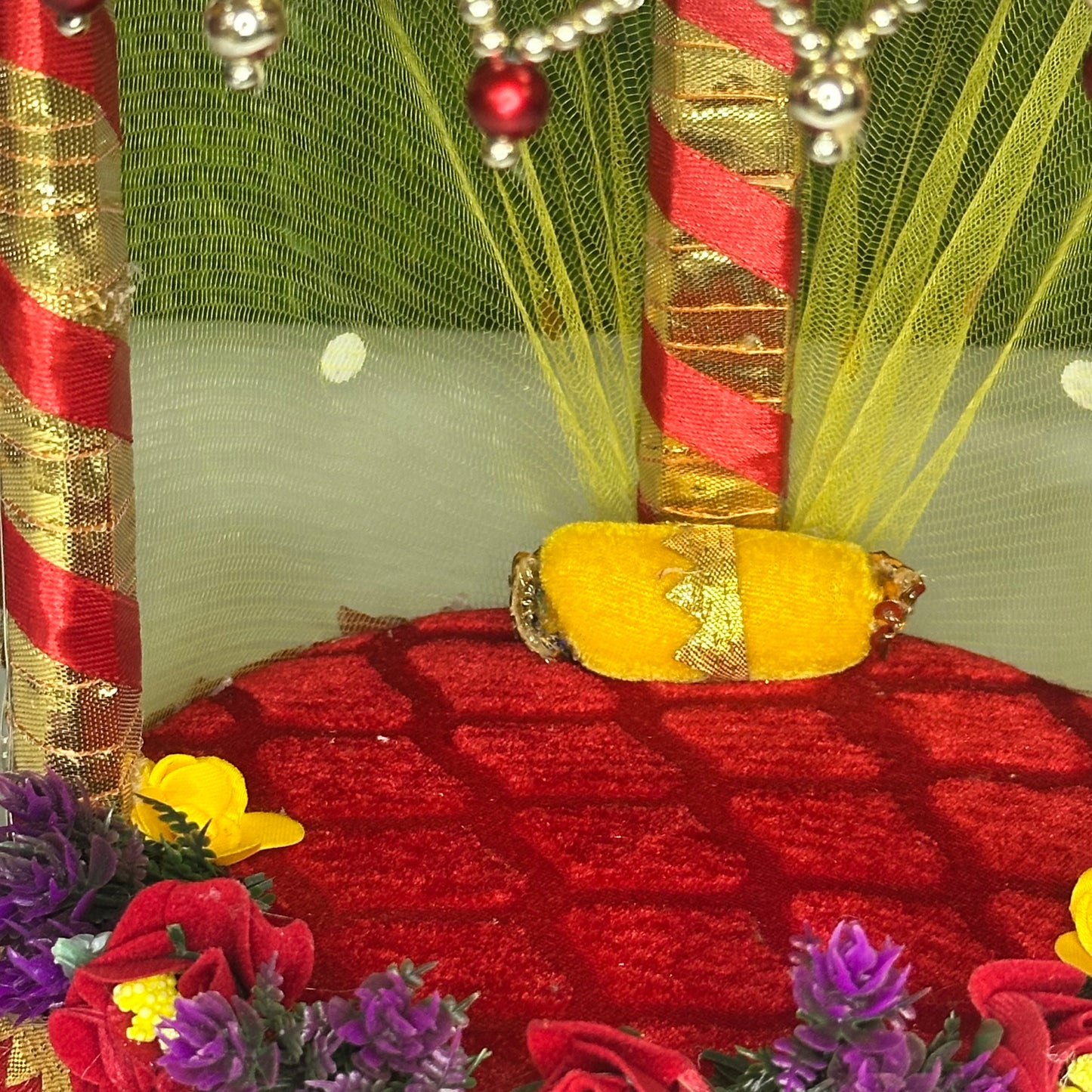 Inside view of a decorative Red Floral Laddu Gopal Singhasan Bed with Pearl Hangings & LED Lights.