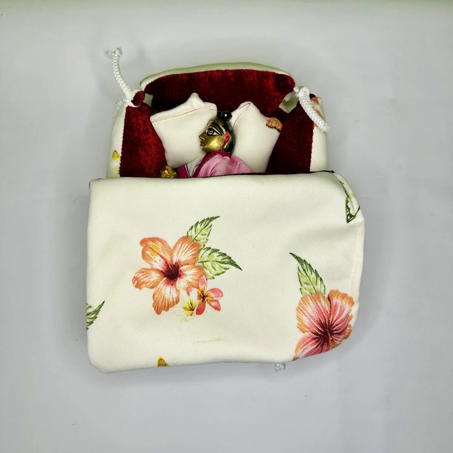 Top View of Laddu Gopal ji sleeping in a Elegant Floral Print Laddu Gopal Bedding Set with Red Velvet Base & Blanket.