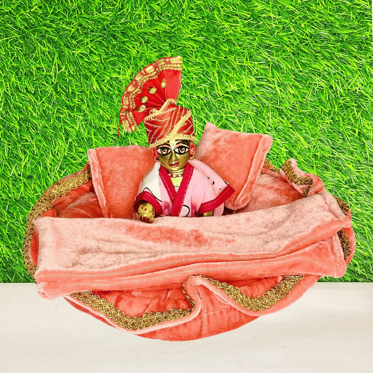 Laddu gopal ji sitting in an Elegant Orange Velvet Laddu Gopal Bedding Set with Golden Lace, Blanket & Pillow.