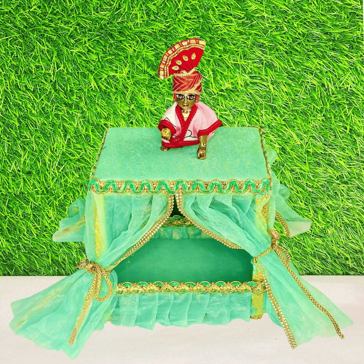 Kanha ji sitting on a Elegant Sea Green Laddu Gopal Jhula Singhasan with Golden Lace Border.