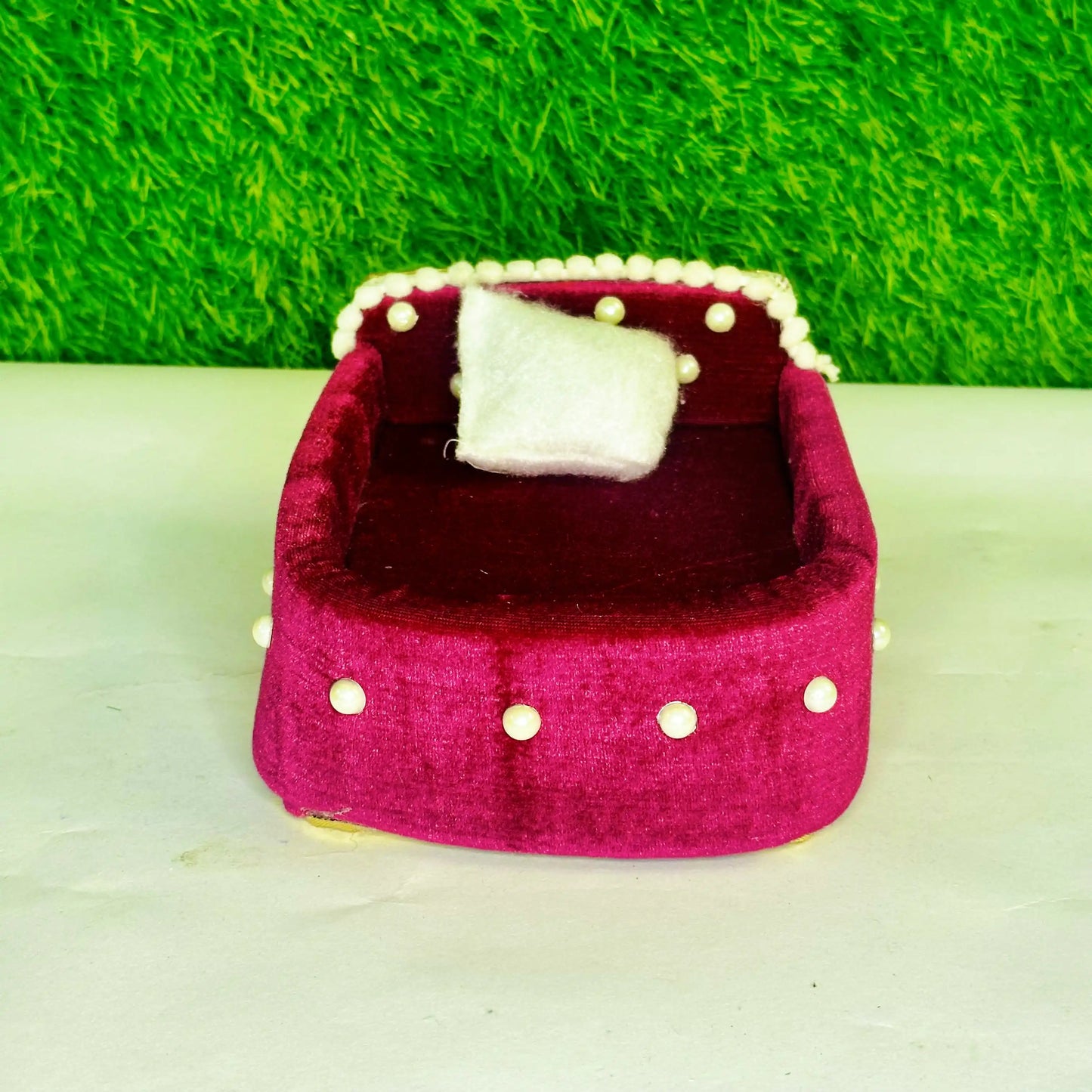 Top view of a Magenta Velvet Laddu Gopal Bedding Set with Pearl Border & Stone Work Blanket.