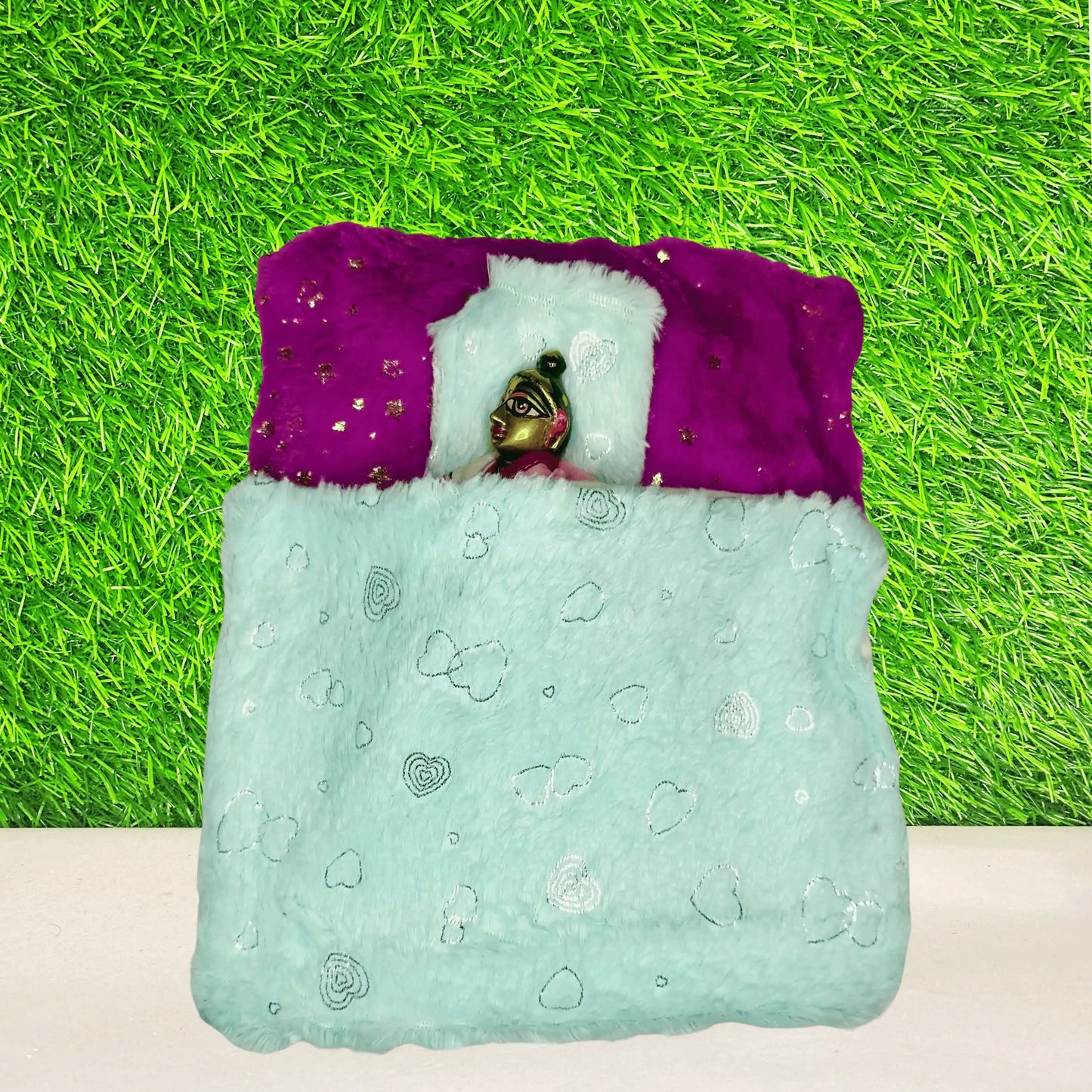 Top view of Laddu gopal ji sleeping in a Mint Green & Purple Furry Laddu Gopal Bedding Set with Heart Print Blanket and Star Base