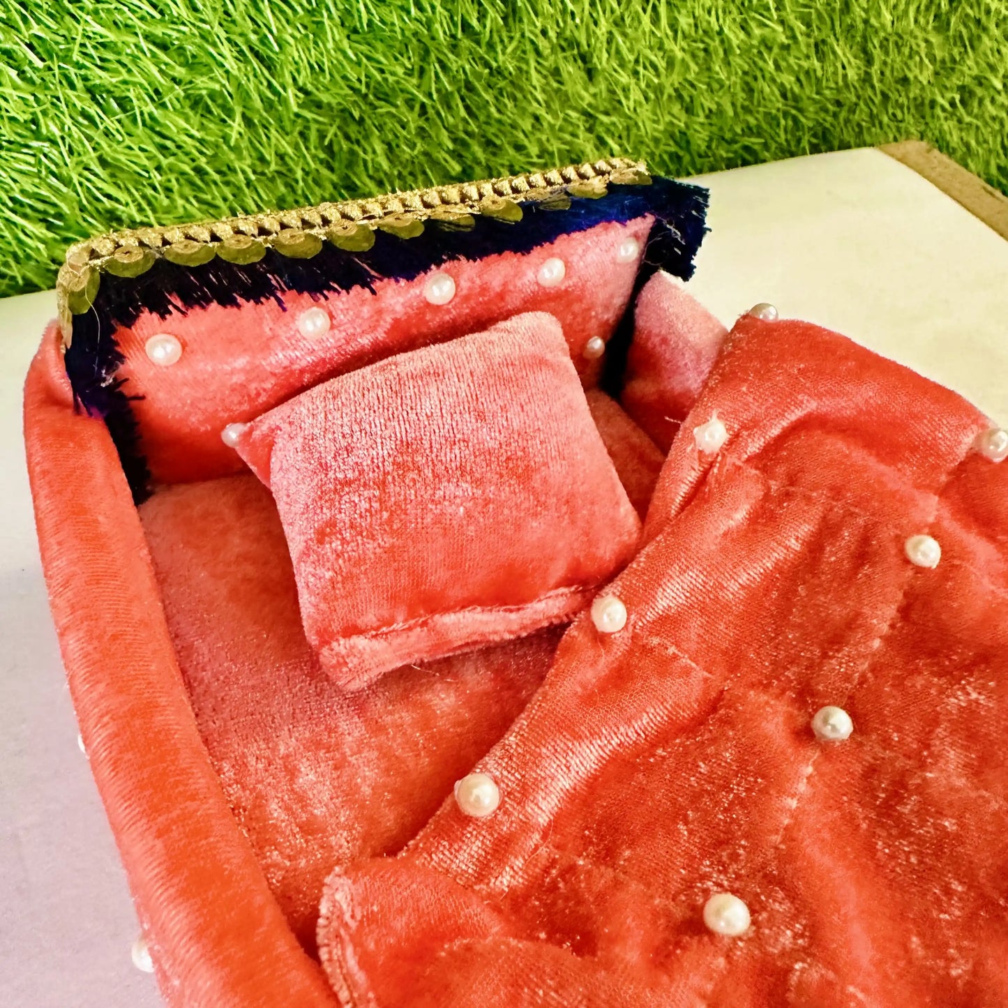 Close view of a Premium Peach Shaneel Laddu Gopal Bedding Set with Pearl Work Blanket & Pillow.