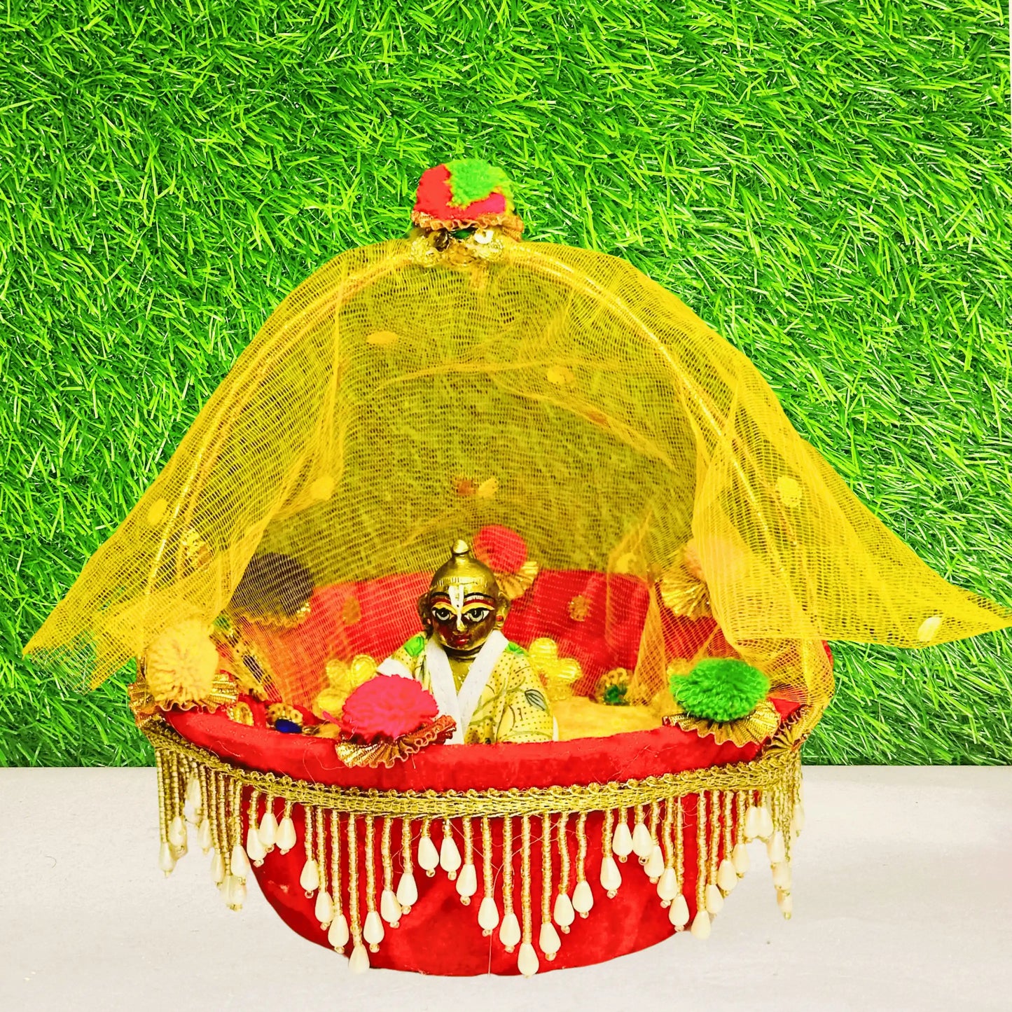 Laddu gopal ji sitting in a Red & Yellow Heavy Lace Work Laddu Gopal Carry Basket.