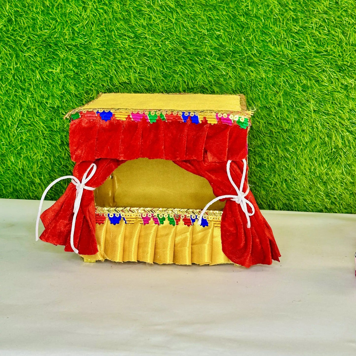 Front view of an attractive Red & Yellow Velvet Laddu Gopal Singhasan with Decorative Jhula.