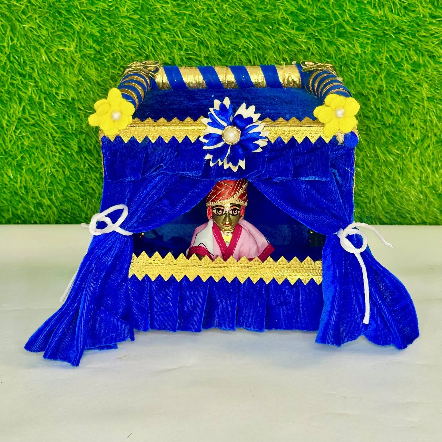 Kanha ji sitting in a Royal Blue Velvet Laddu Gopal Singhasan Jhula, Beautiful Floral Decoration.