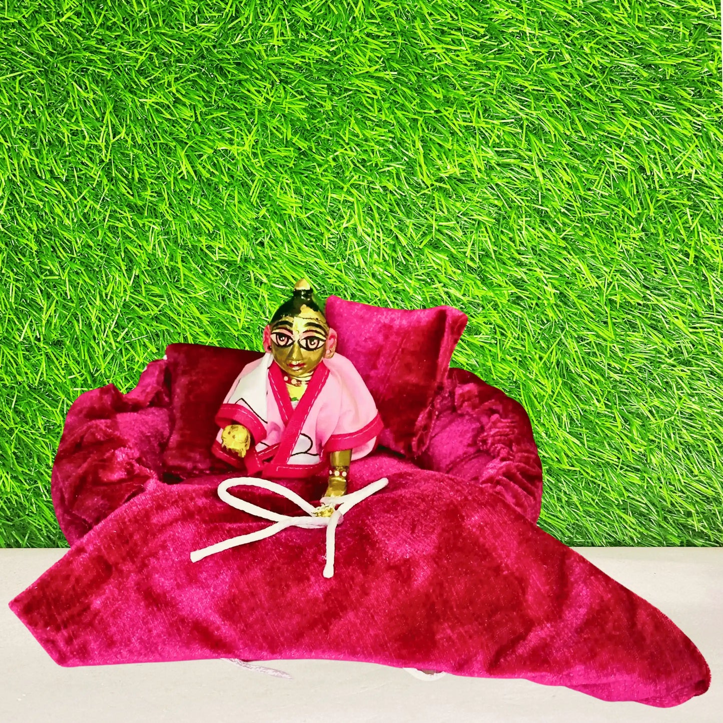 Laddu gopal ji sitting in a Royal Magenta Velvet Laddu Gopal Bedding Set with Designer Bow Blanket & Pillow.