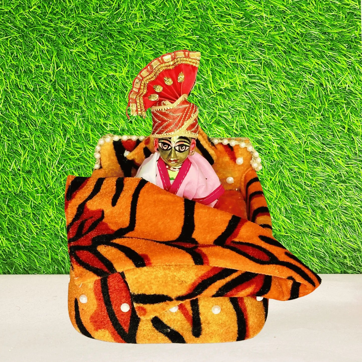 Laddu gopal ji sitting in a Tiger Print Soft Velvet Laddu Gopal Bedding Set with Pearl Work & Blanket.
