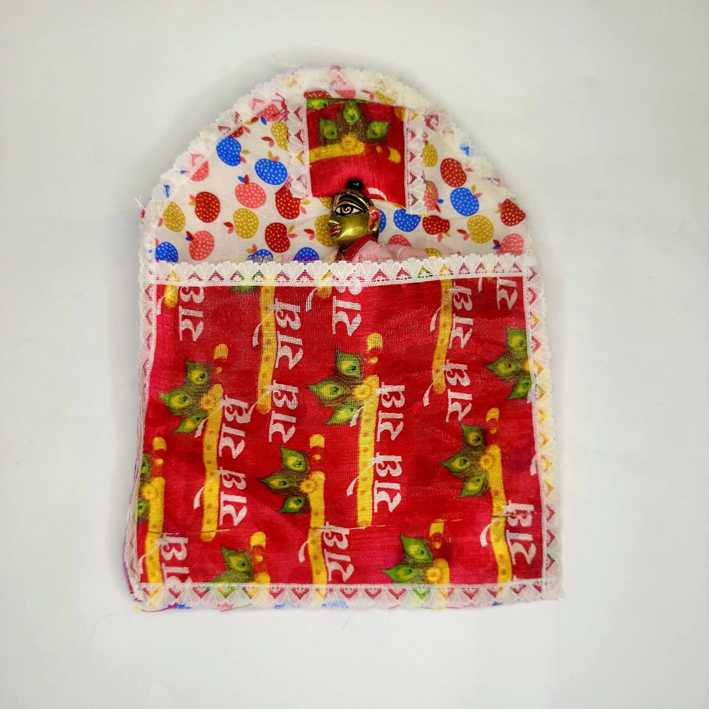 Top view of Laddu Gopal ji sleeping on a Traditional Cotton Printed Laddu Gopal Bedding Set with Red Radhe Radhe Blanket & Strawberry color Base.