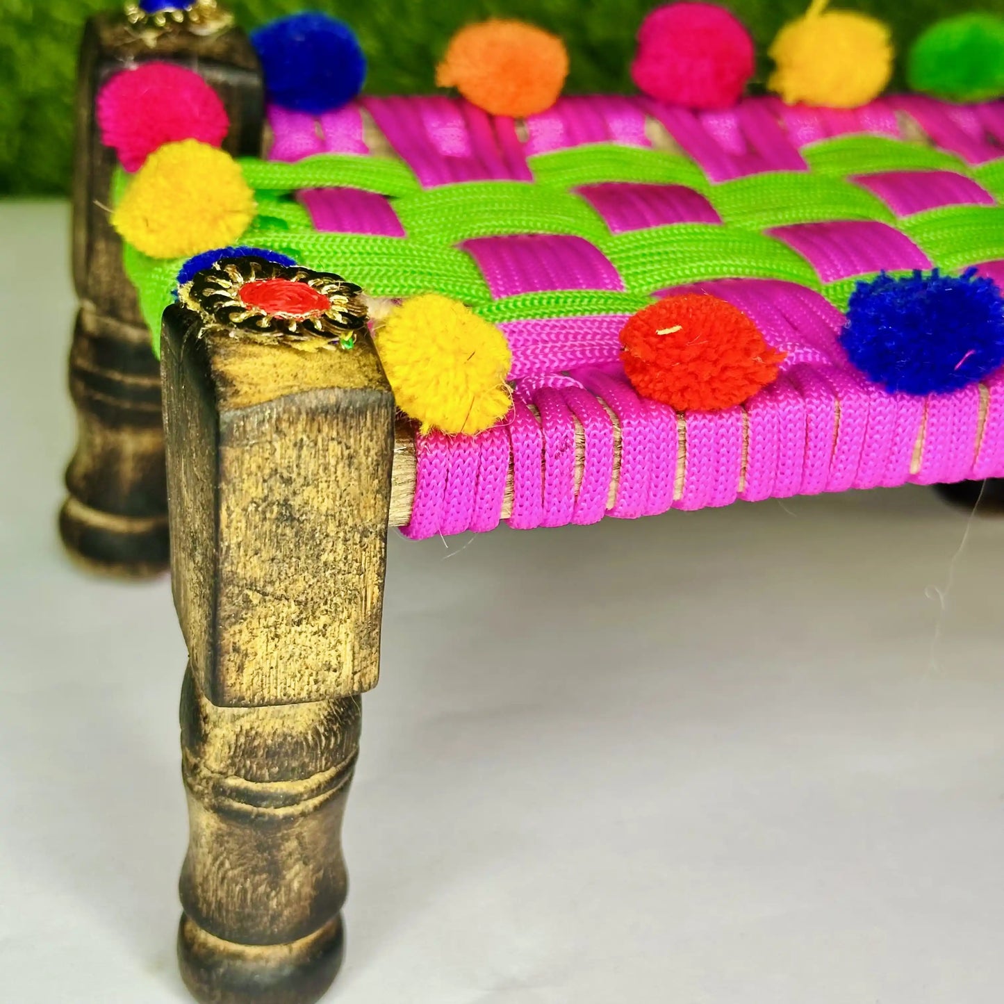 Side view of a Traditional Multicolor Pom-Pom Charpai for Laddu Gopal Ji.