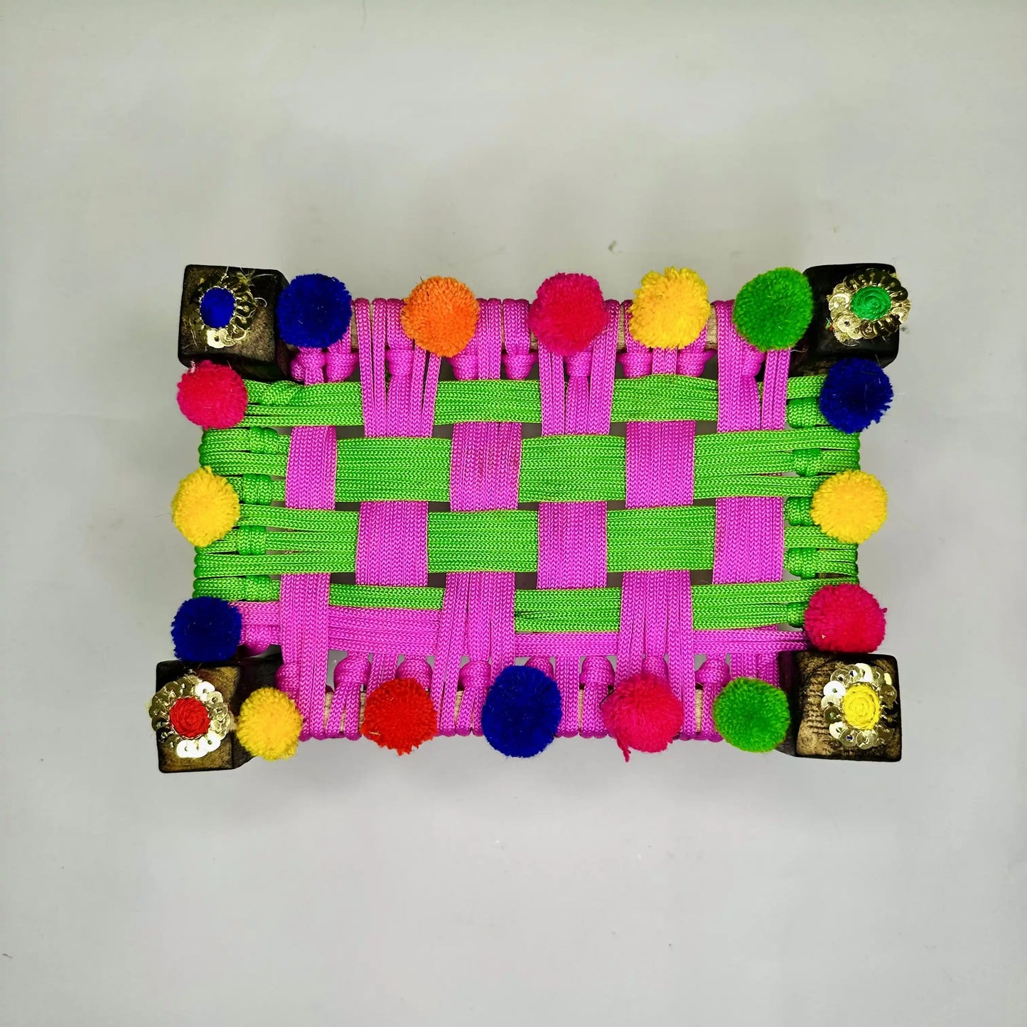 Top view of a Traditional Multicolor Pom-Pom Charpai for Laddu Gopal Ji.
