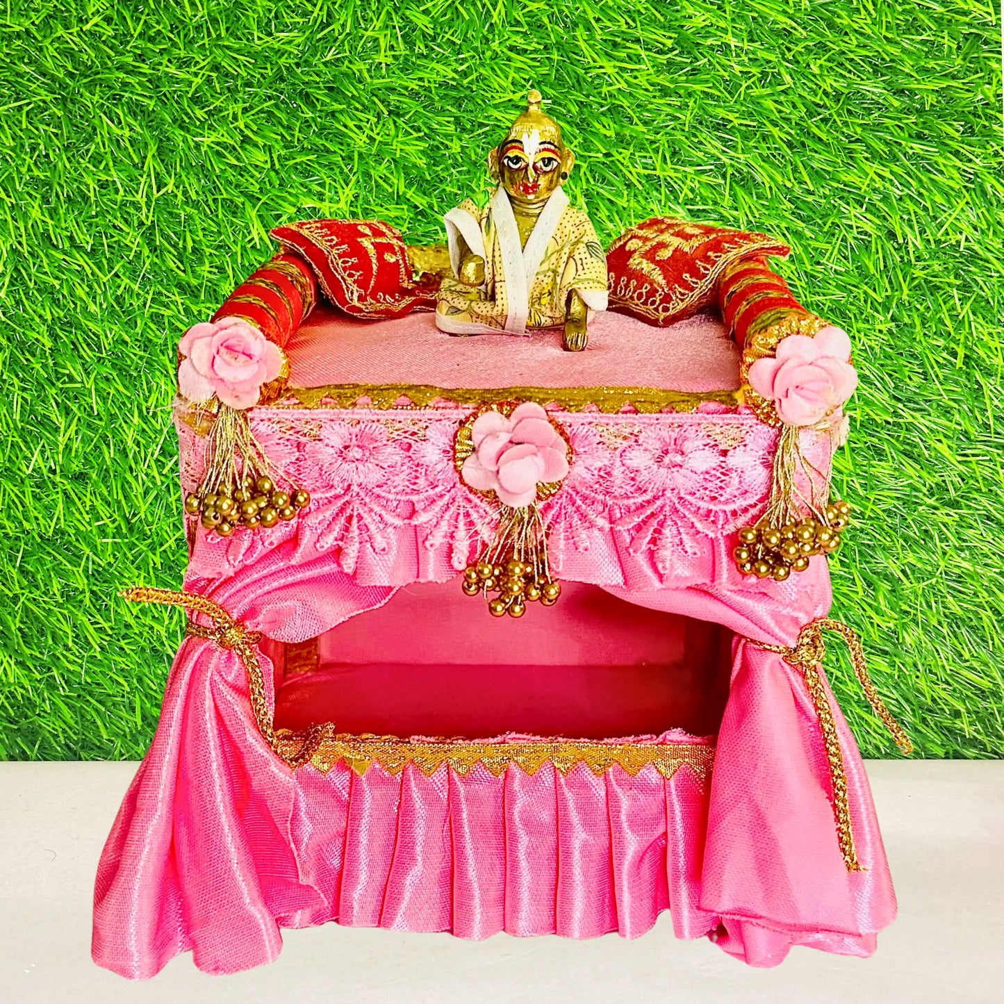Kanha ji sitting on a Unique Wooden Pink Silk Laddu Gopal Bed cum Singhasan.