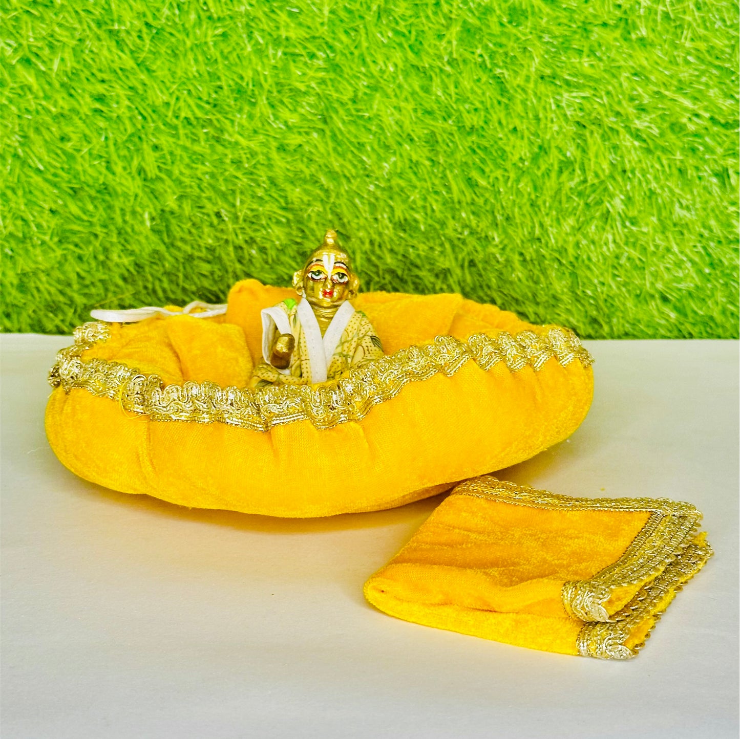 Main view of Kanha ji sitting on a Yellow Shaneel Laddu Gopal Bedding Set with Blanket & Pillow.