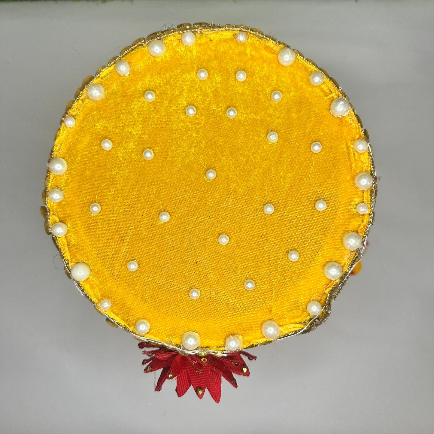 Top view of a Royal Yellow Velvet Singhasan for kanha Ji with Pom-Pom Curtains, Pearl Decoration & LED Lights.